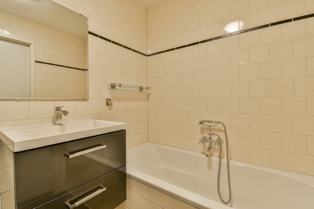 Bathroom with white tiled walls